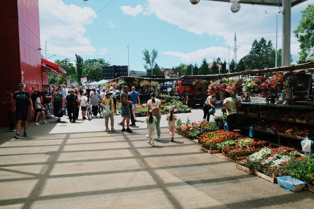 a group of people walking around a market
